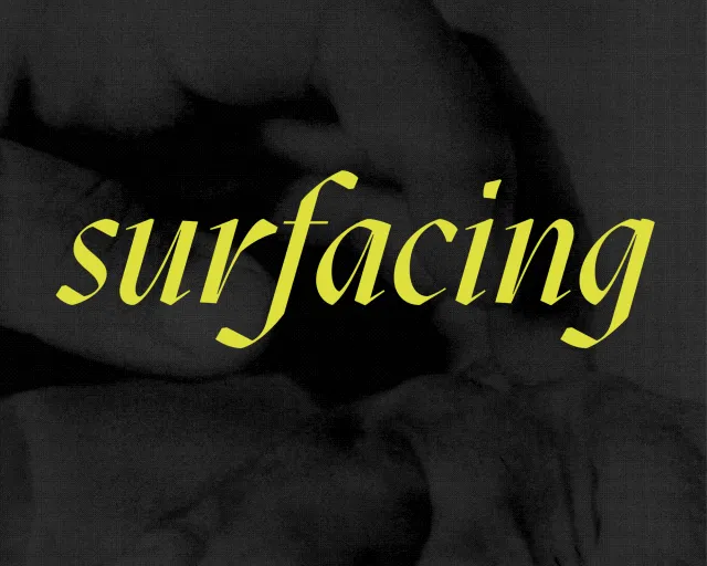 The exhibition title "surfacing" in bright yellow italic font, overlaid on a dark grey background of a cyanotype of two hands.